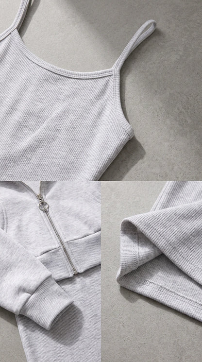 Close-up details of ribbed knit texture, spaghetti strap, and stitched hemline