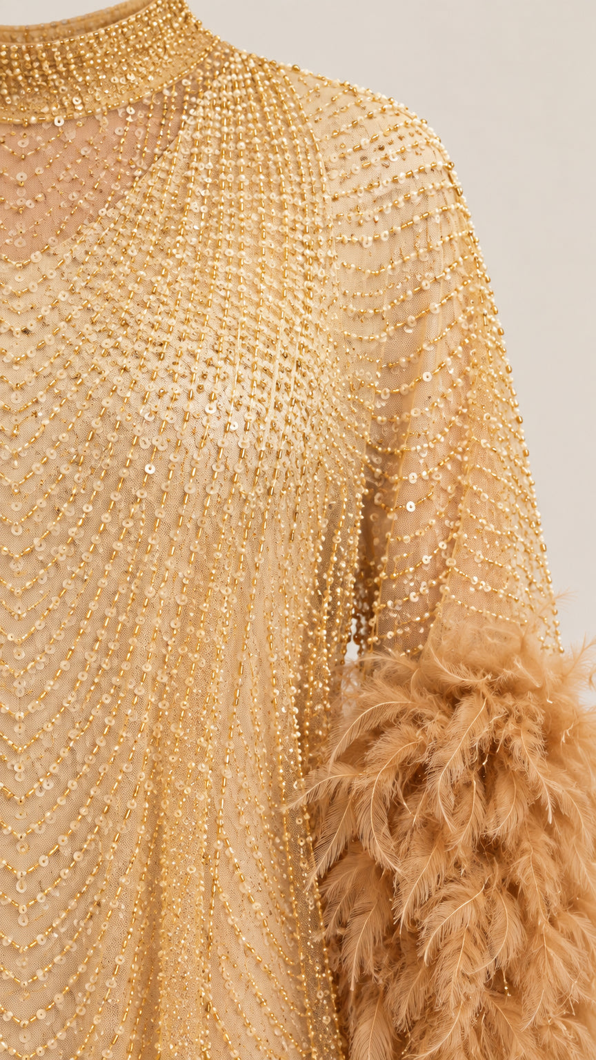 Close-up detail of shimmering linear beadwork and plush feather cuffs on Champagne Gold gown