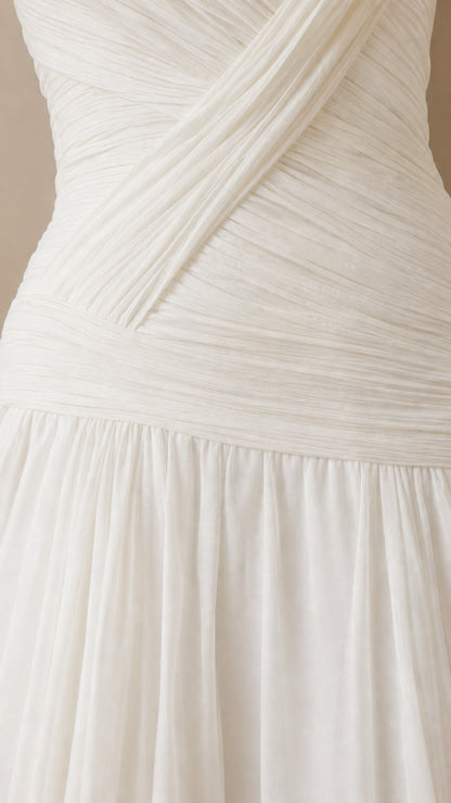 Close-up detail of white criss-cross pleated bodice and drop-waist seam