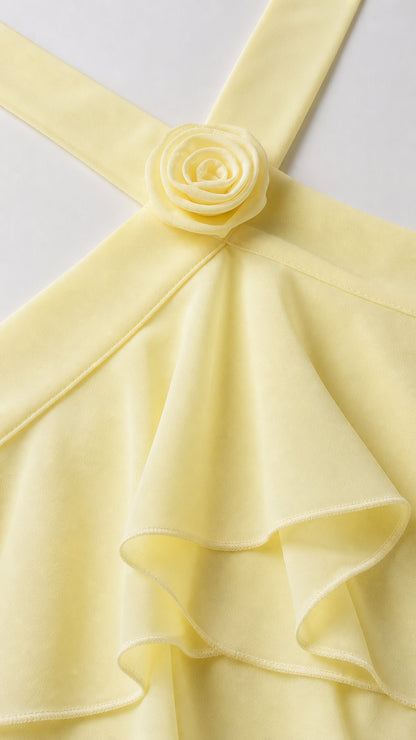 Close-up detail of 3D fabric flower applique on yellow halter neckline