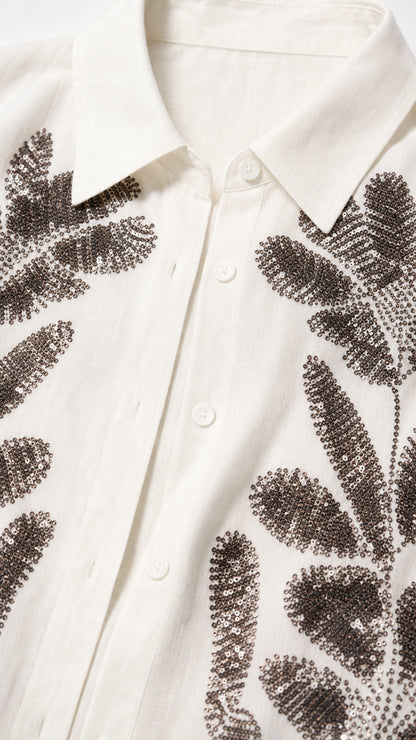 Close-up detail of shirt collar and beaded leaf embroidery