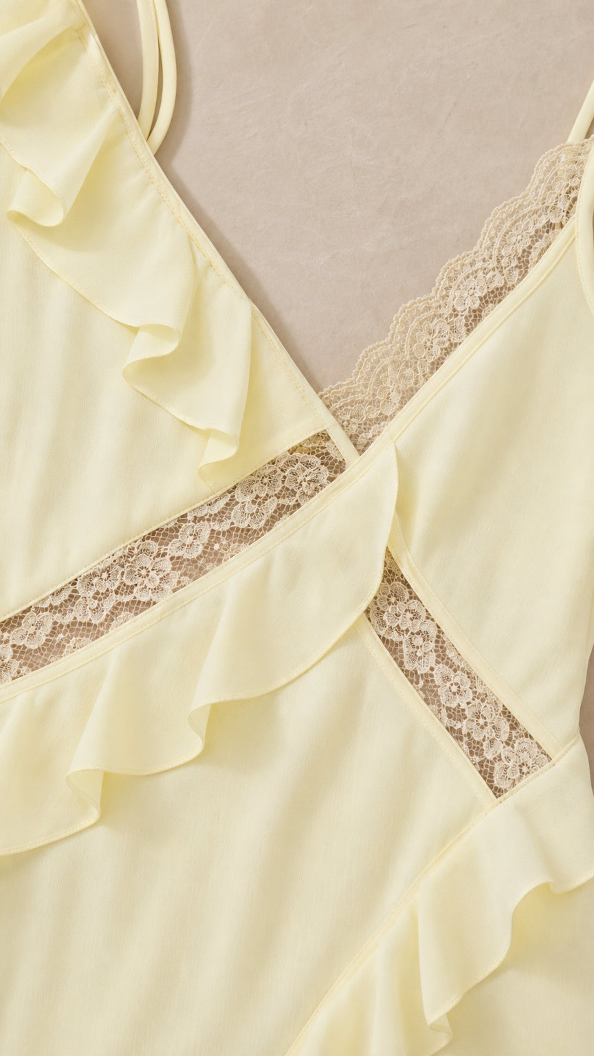 Close-up detail of lace trim and ruffle on yellow dress