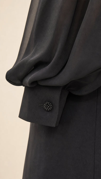 Close-up of sheer bishop sleeve and buttoned cuff detail