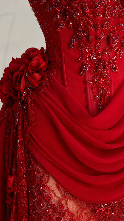 Close-up detail of red 3D floral beading, corset boning, and draped sash