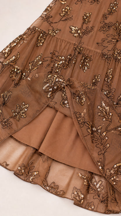 Close-up of sequin floral embroidery and tiered hem