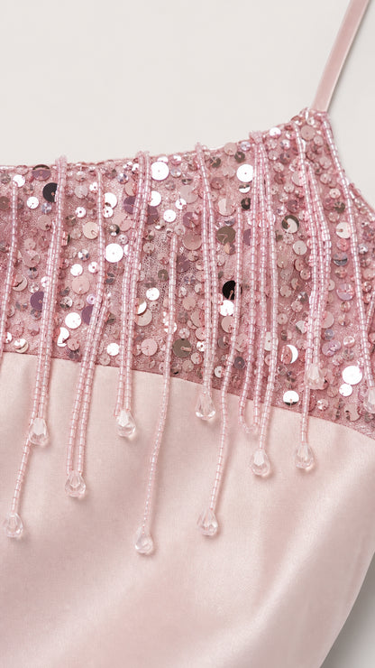 Close-up detail of sequin and beaded fringe on pink camisole