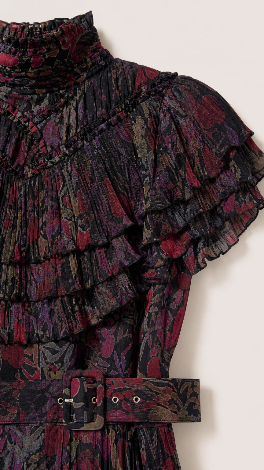Close-up detail of high ruffled collar, shoulder ruffles, and matching belt