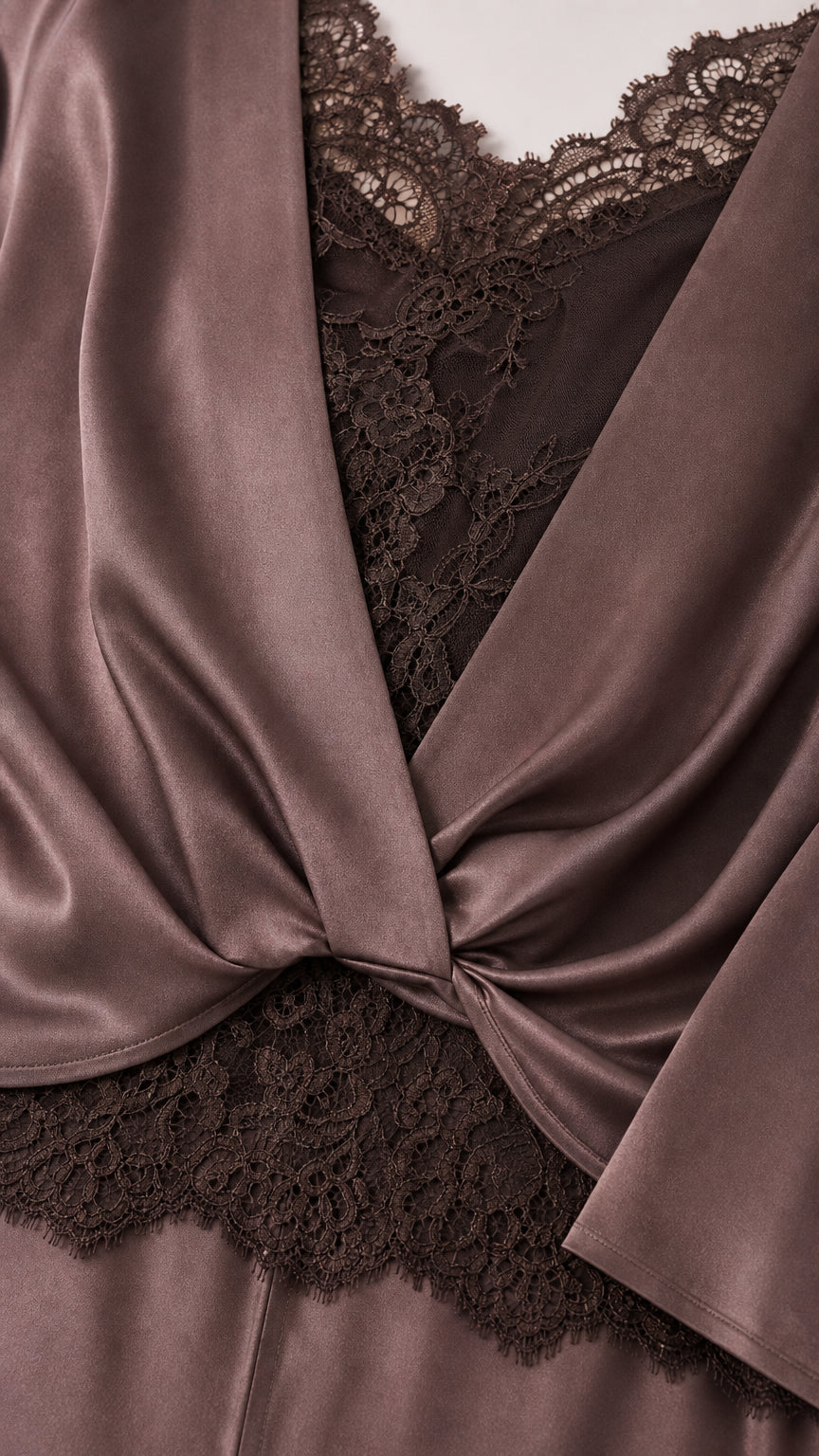 Close-up detail of lace trim neckline and twist-front satin fabric in taupe