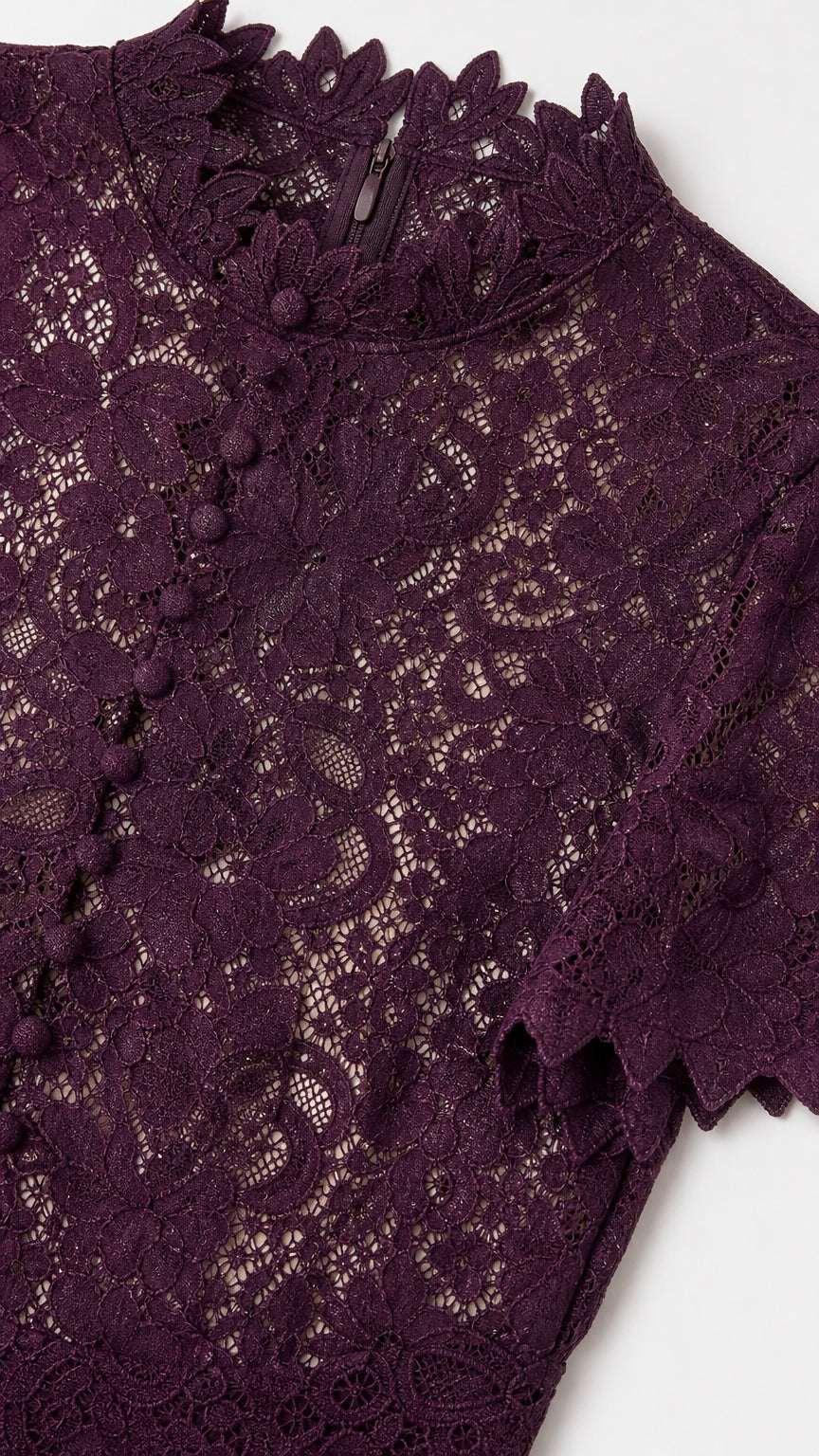Close-up detail of Plum floral lace fabric, scalloped mock collar, and button placket