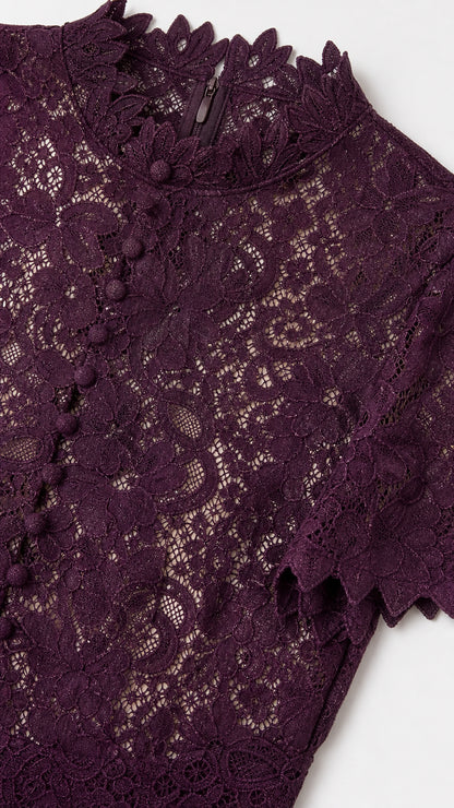 Close-up detail of Plum floral lace fabric, scalloped mock collar, and button placket