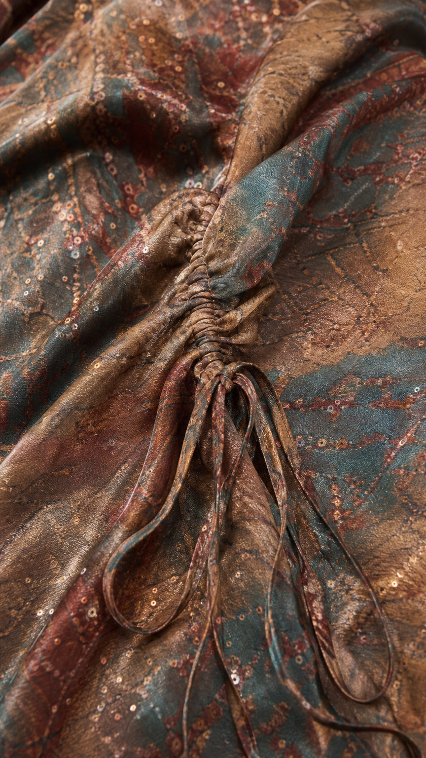 Close-up detail of the textured abstract printed fabric and ruched drawstring shoulder ties