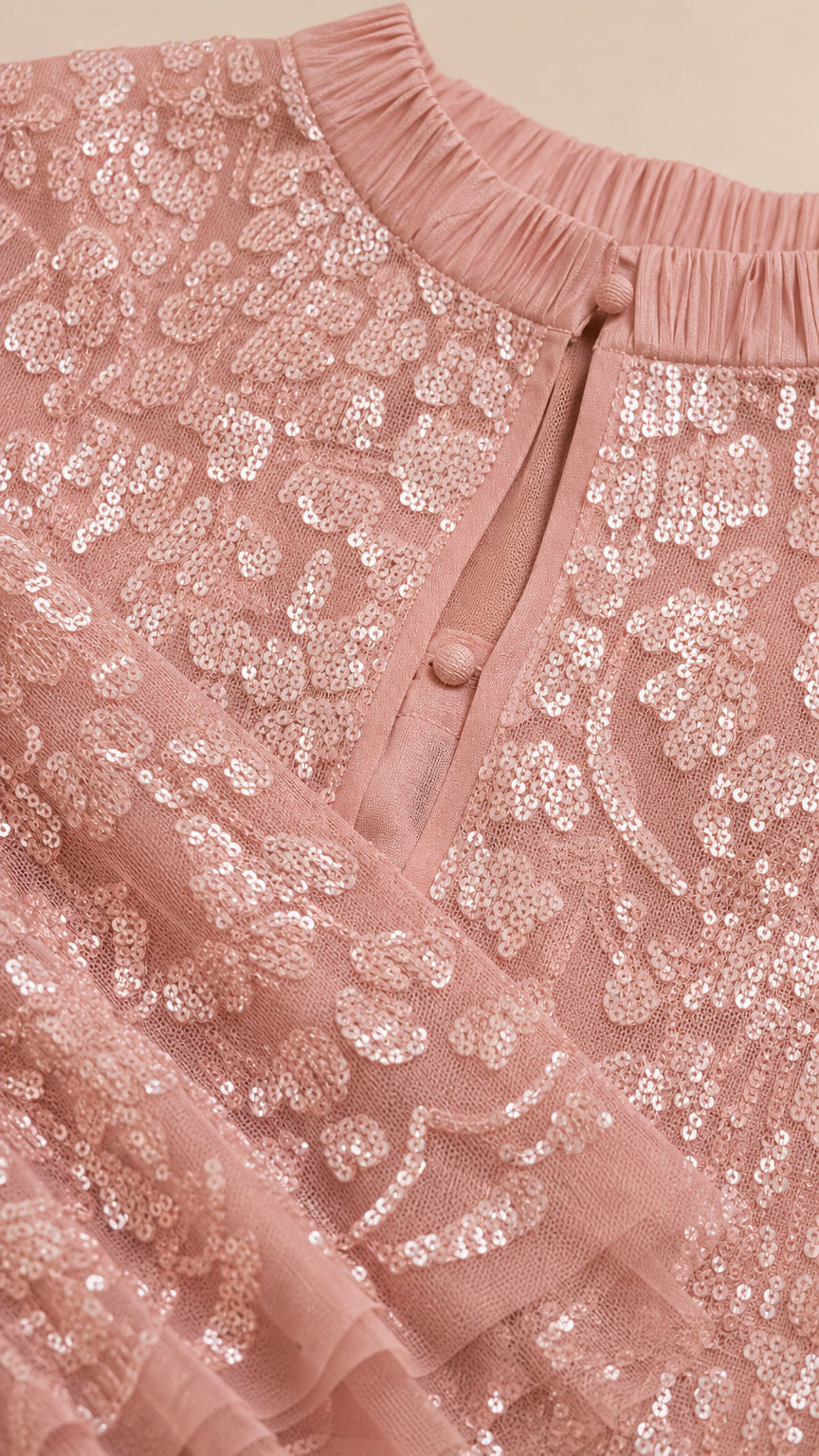 Close-up of keyhole neckline and sequin texture in Dusty Rose