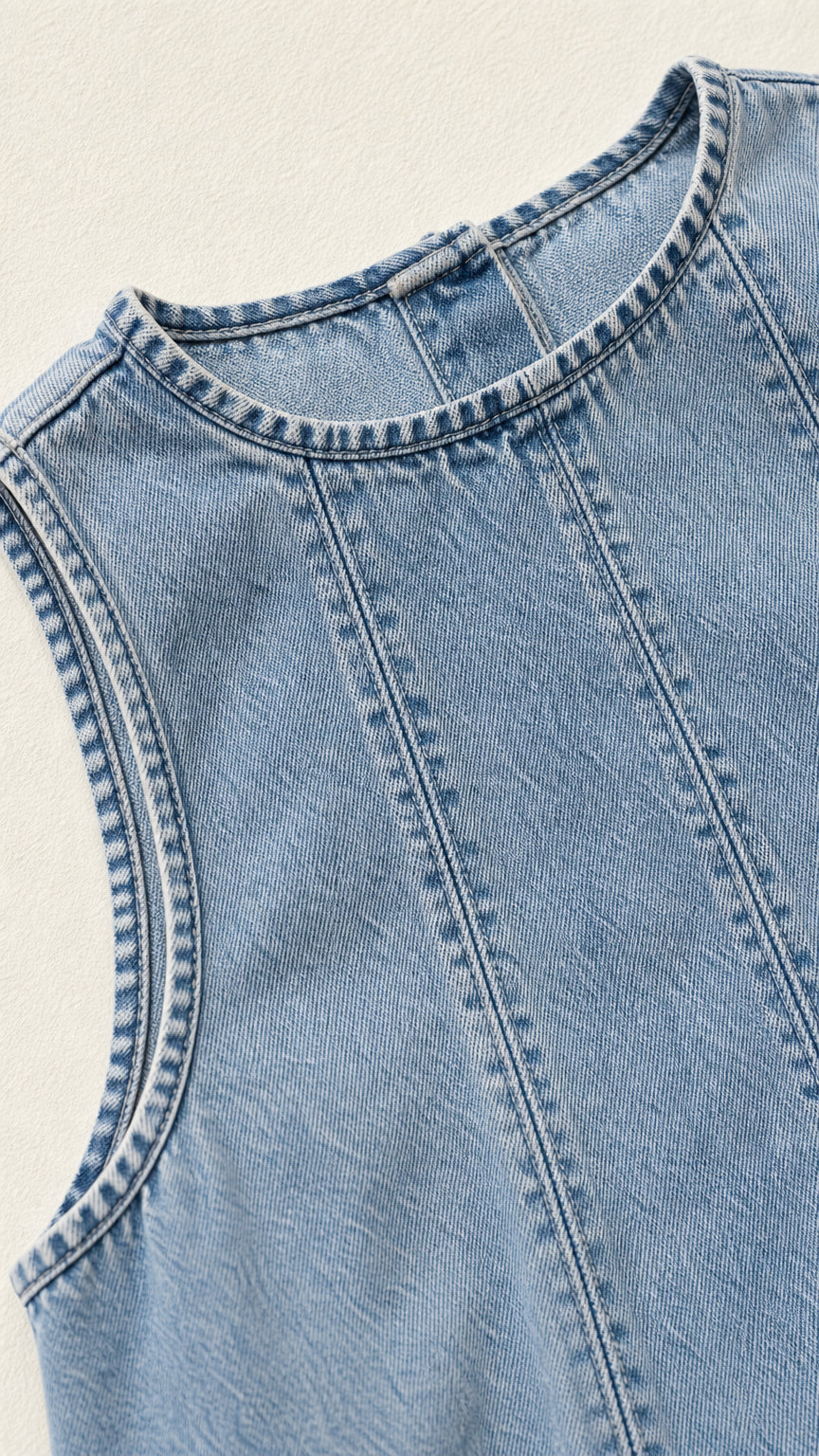 Close-up of crew neckline and vertical panel seams on Light Blue denim dress