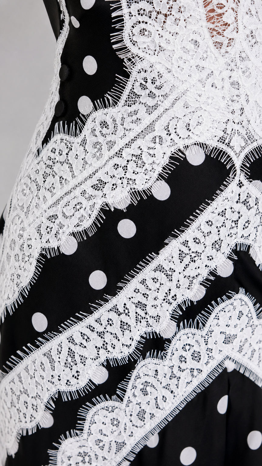 Close-up detail of white eyelash lace overlay and polka dot fabric