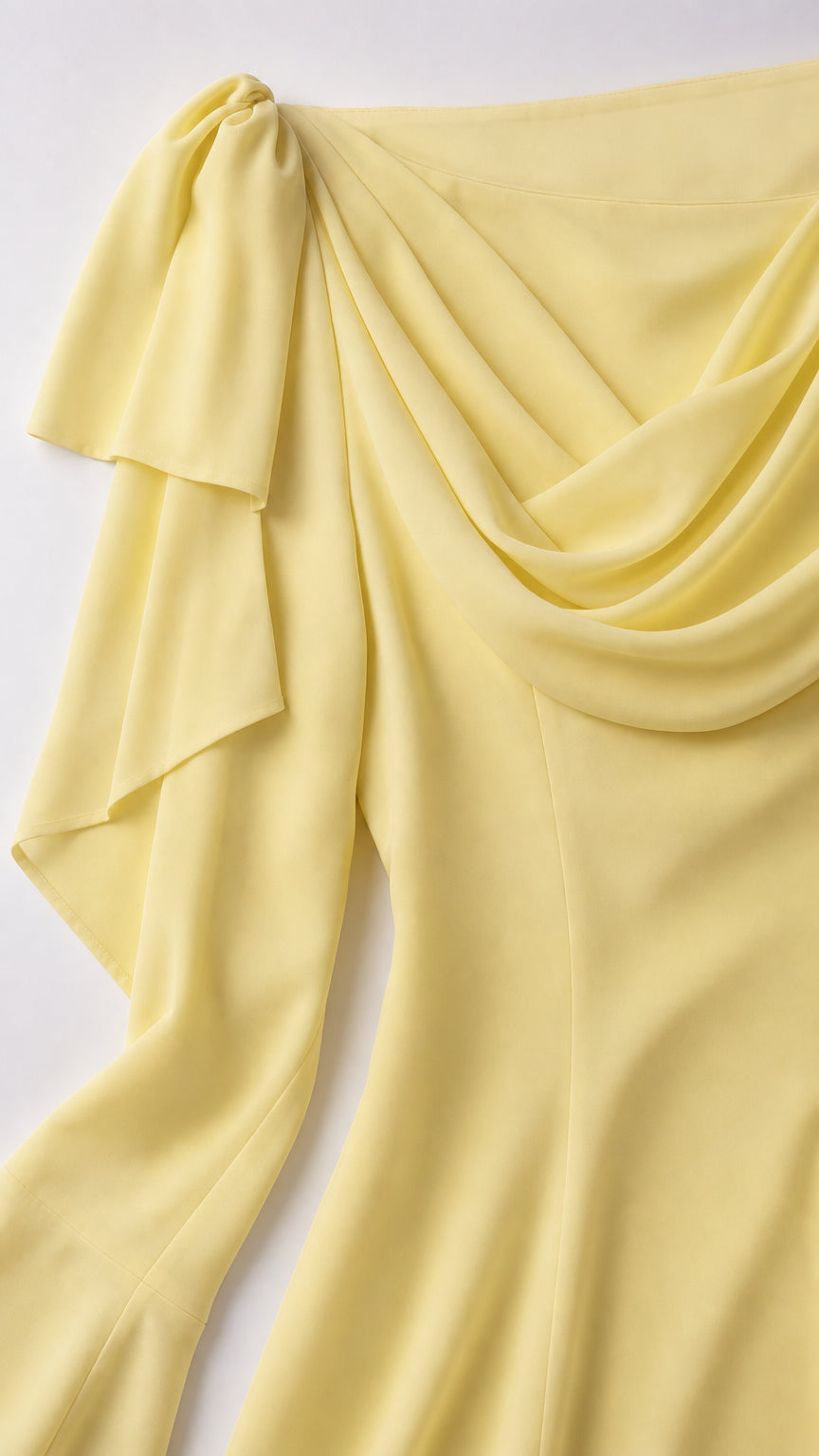 Close-up of shoulder bow and fabric drape on yellow dress