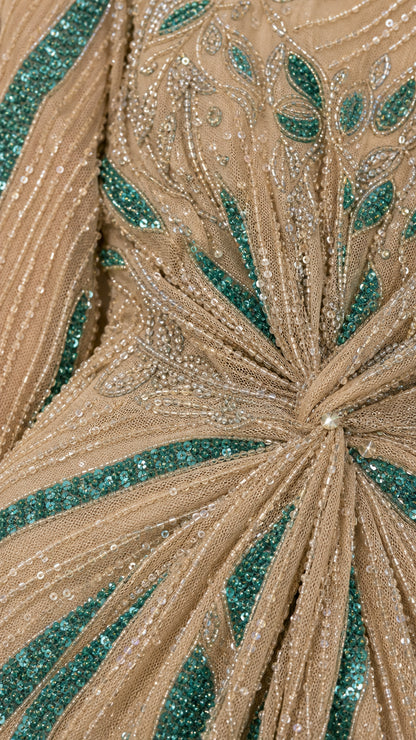 Close-up detail of sequin and bead embellishments on champagne dress