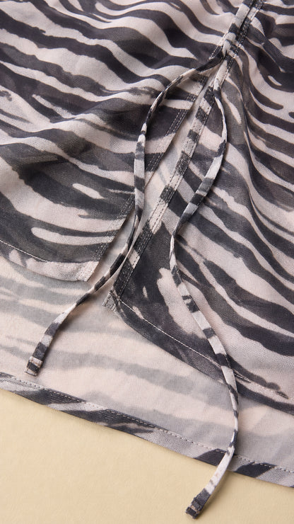 Close-up detail of side ruching and drawstring on zebra print dress