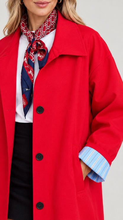 Close-up detail of Red trench coat showing lapel, front button fastening, and striped cuff lining