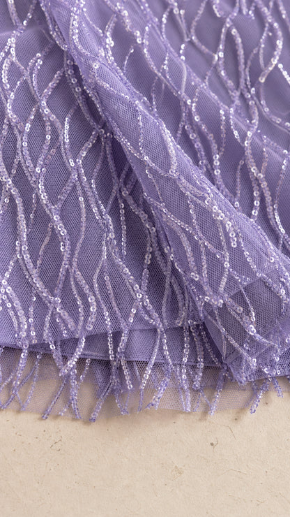 Close-up of lavender mesh fabric with sequin and fringe texture