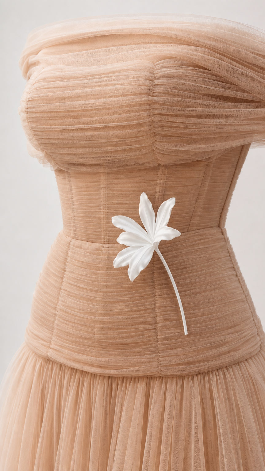 Close-up detail of pleated tulle bodice and white floral applique