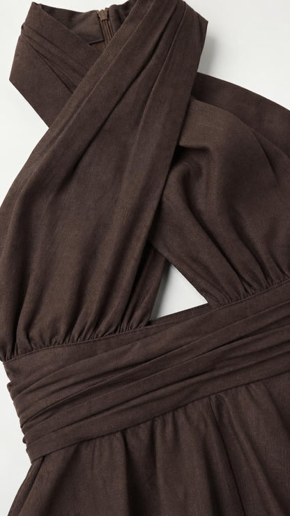 Close-up of the chocolate brown halter neckline, waist seam, and smooth-looking woven fabric