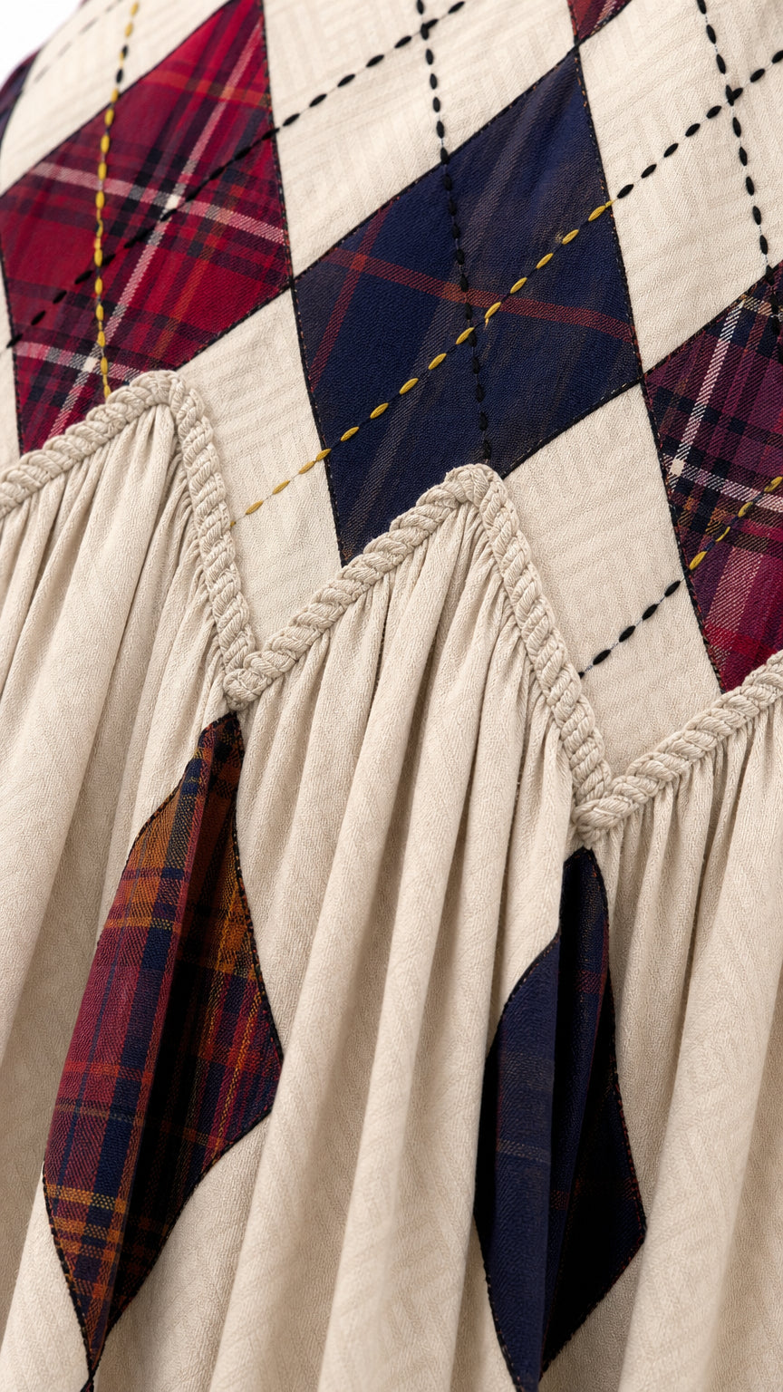 Close-up detail of argyle plaid print and braided waist trim