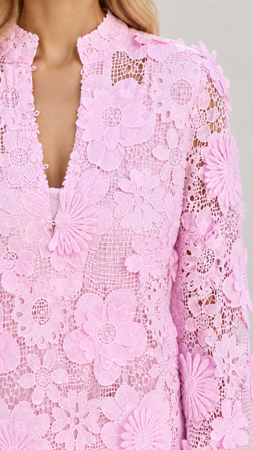 Close-up detail of split notch neckline and 3D floral lace embroidery