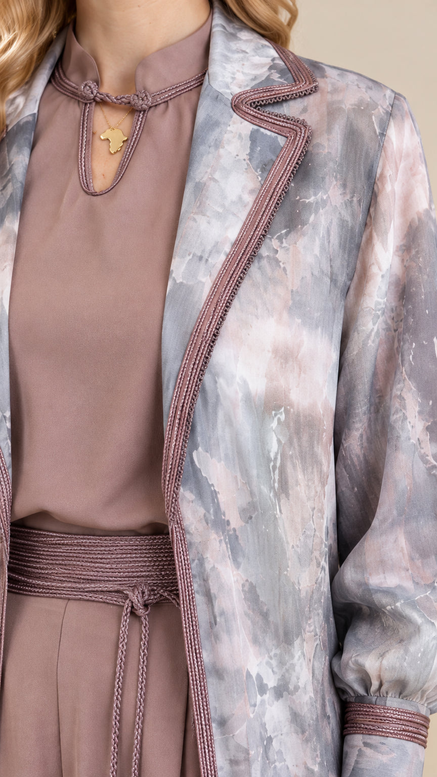 Close-up detail of neckline, braided trim, and tassel belt on dusty mauve set