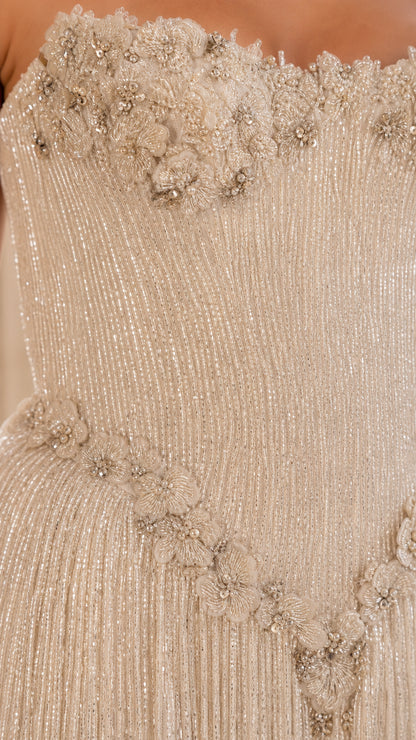 Close-up detail of beaded bodice and floral appliques
