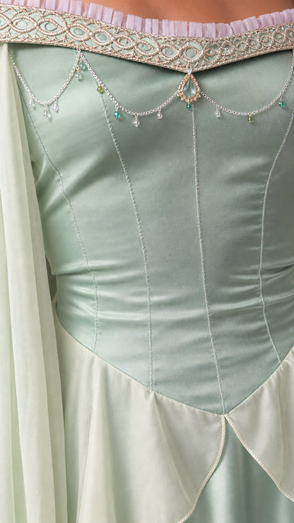Close-up detail of beaded neckline and bodice seaming on sage green dress