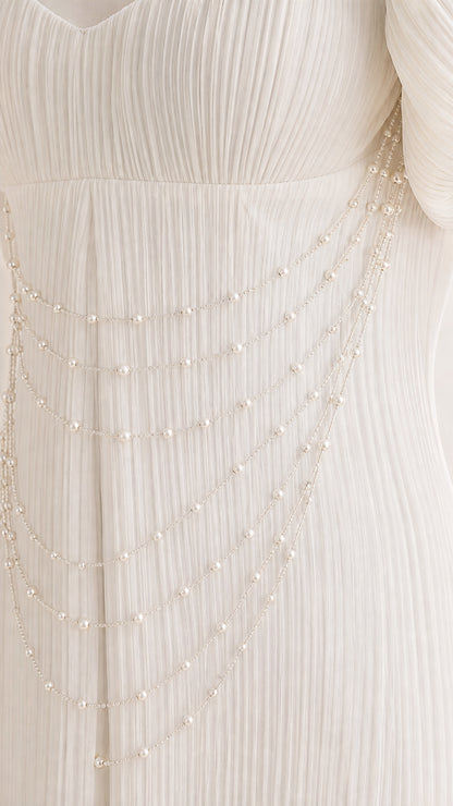 Close up of pearl bead drapes and micro-pleated fabric