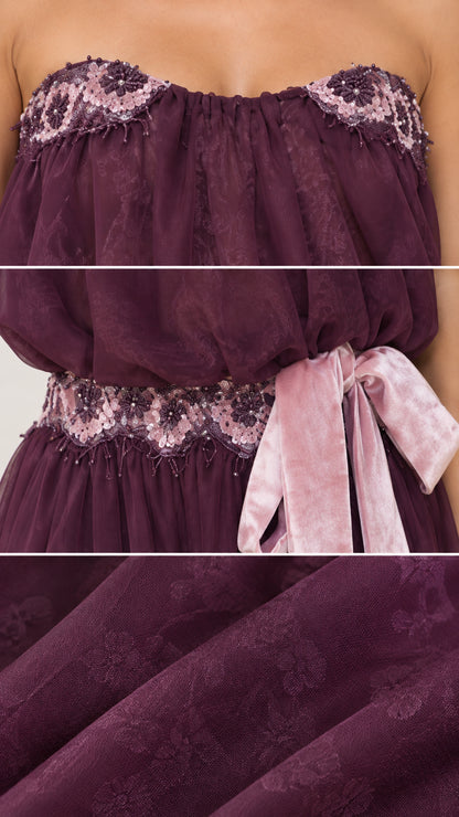 Close-up details of lace neckline, waist trim, and ribbon sash on Plum gown