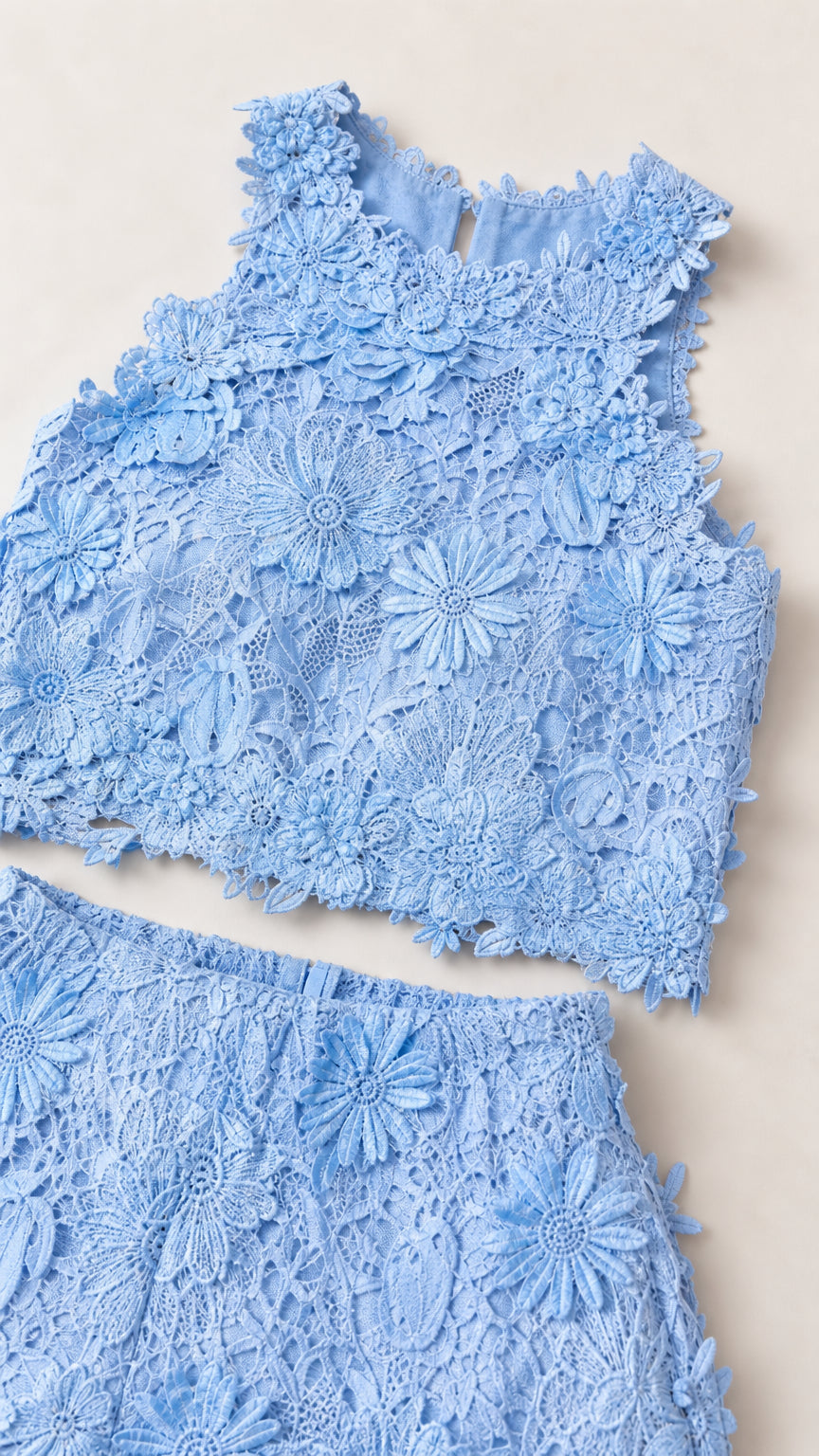 Flat lay detail of blue floral lace crop top and pants