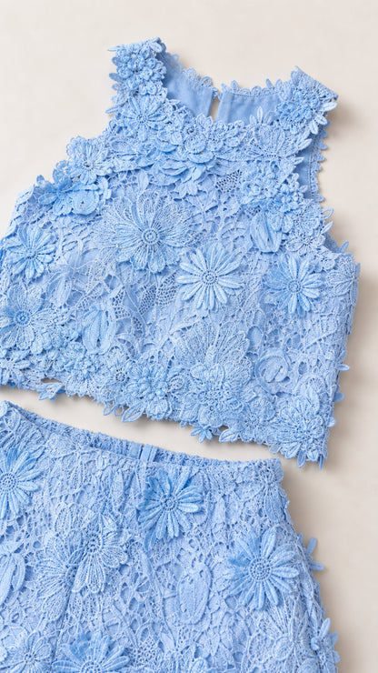 Flat lay detail of blue floral lace crop top and pants