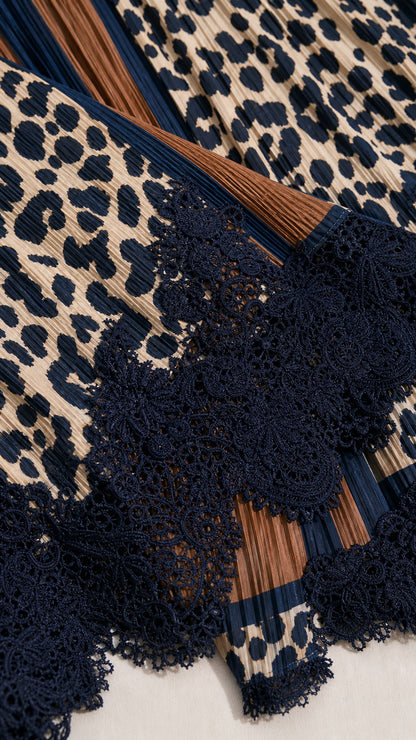 Close-up detail of accordion pleating, leopard pattern, and scalloped dark lace hem
