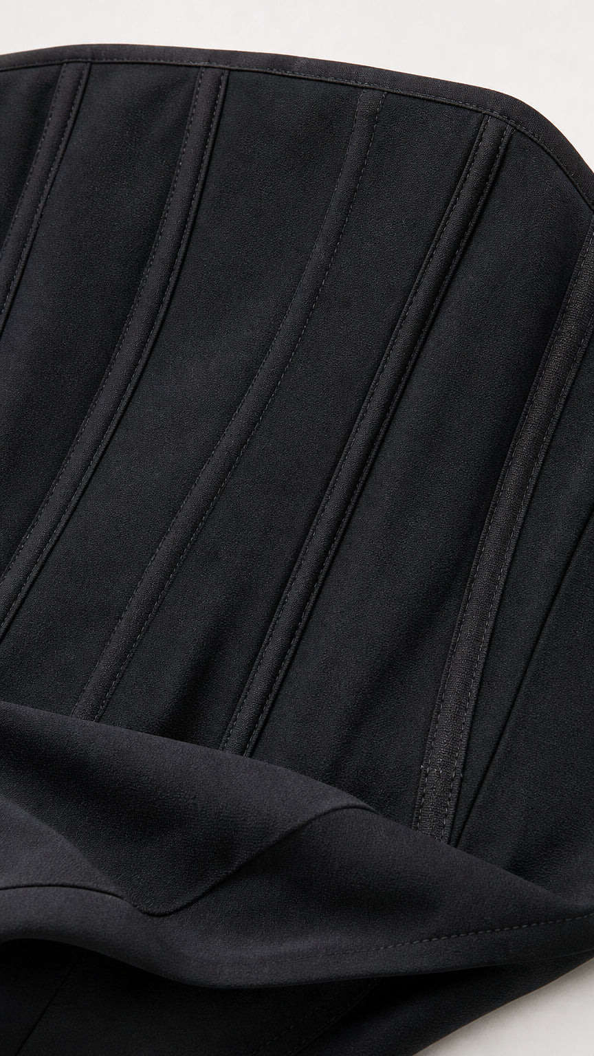 Close-up detail of structured black bodice with vertical seams