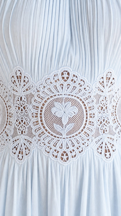 Close-up detail of sheer lace waist panel on the dress