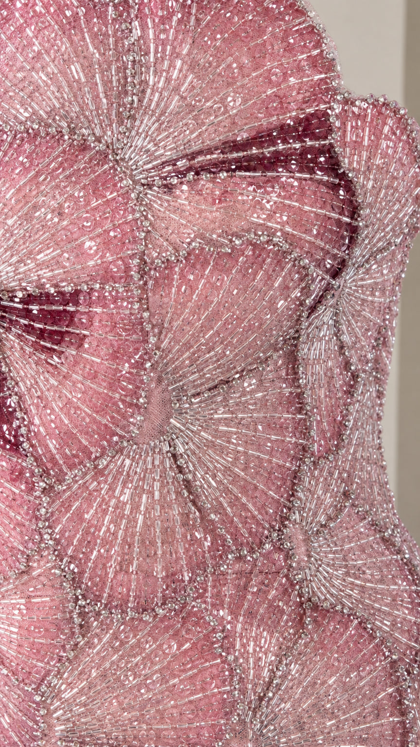 Close-up detail of textured petal shimmer embellishments on dusty rose fabric