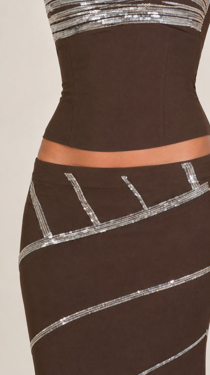 Close-up detail of sequin band trim on chocolate brown bodice and skirt