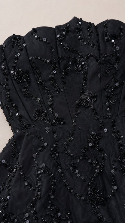 Close-up detail of black corset bodice with intricate sequin and bead embellishments