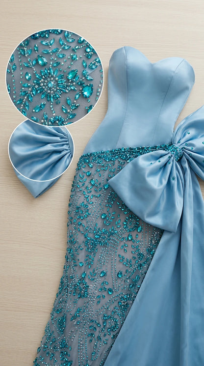 Close-up detail of intricate crystal beadwork and satin bow craftsmanship on sky blue gown
