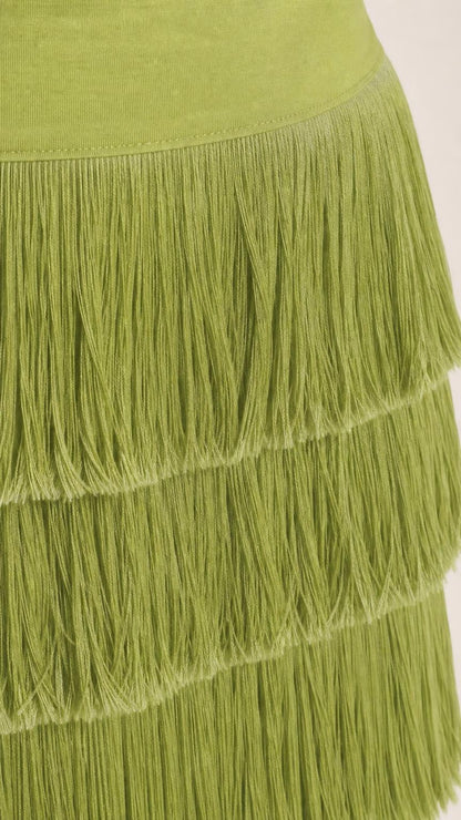 Close up view of the fringe tiers on the olive green dress