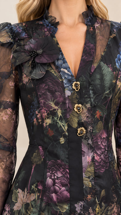 Close-up of decorative buttons and floral neckline applique on black dress