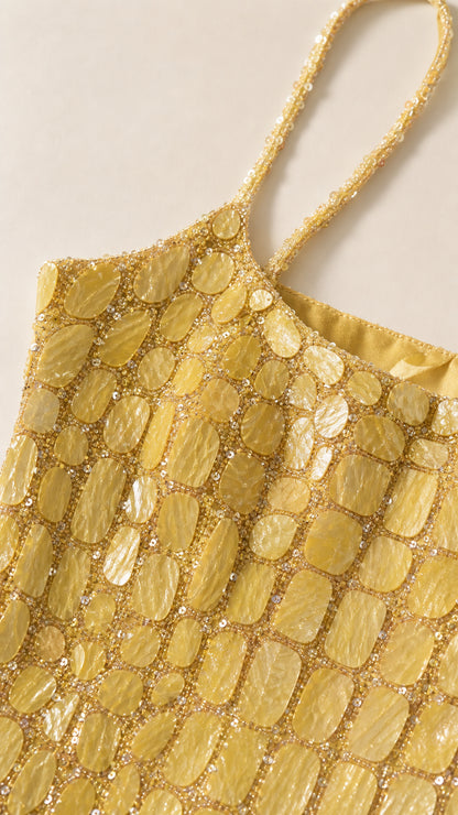 Close-up detail of yellow square sequins and beaded straps
