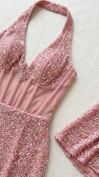 Close-up detail of sheer illusion corset boning and sequin embroidery on halter top