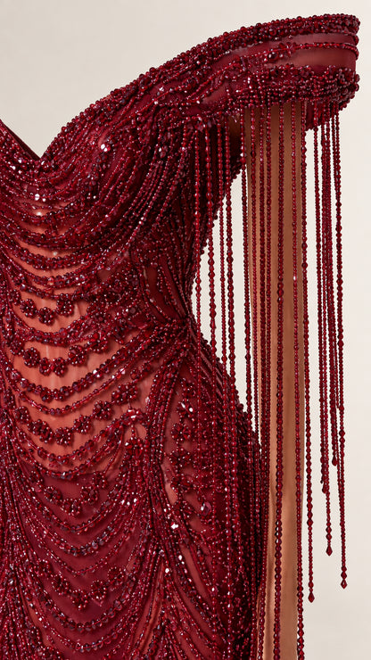 Close-up detail of burgundy sequin embellishment and cascading beaded fringe
