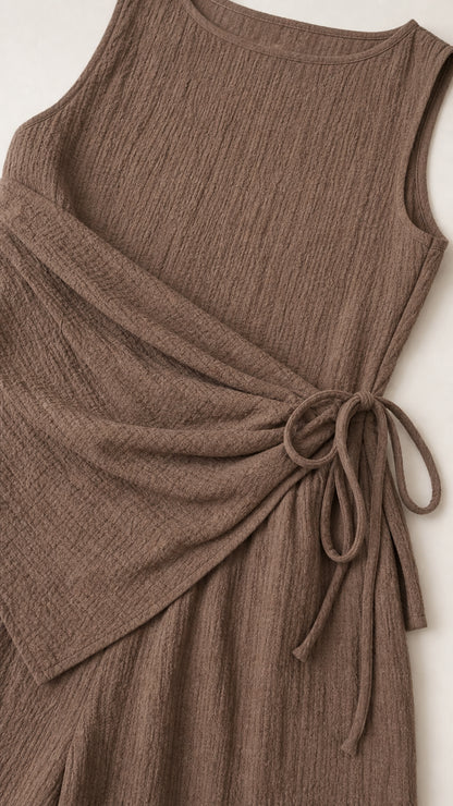 Close up of textured fabric and side tie detail on brown top
