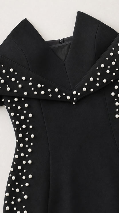 Close-up detail of off-the-shoulder collar with delicate pearl embellishments