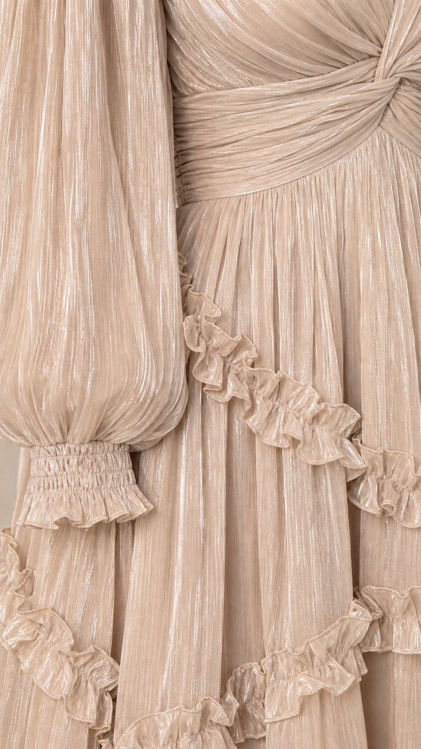 Close-up detail of pleated shimmer texture, smocked cuffs, and delicate ruffles