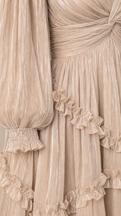 Close-up detail of pleated shimmer texture, smocked cuffs, and delicate ruffles